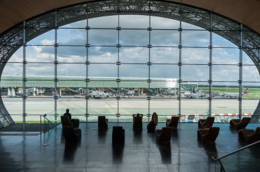 Paris, France, April 1 2017: Looking out a large ellipsoid window at Charles De Gaulle airport clipart