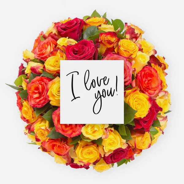 Fresh flowers bunch and card with words i love you written on it — Stock Photo, Image