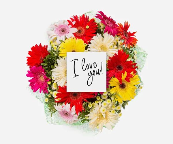 Fresh flowers bunch and card with words i love you written on it — Stock Photo, Image