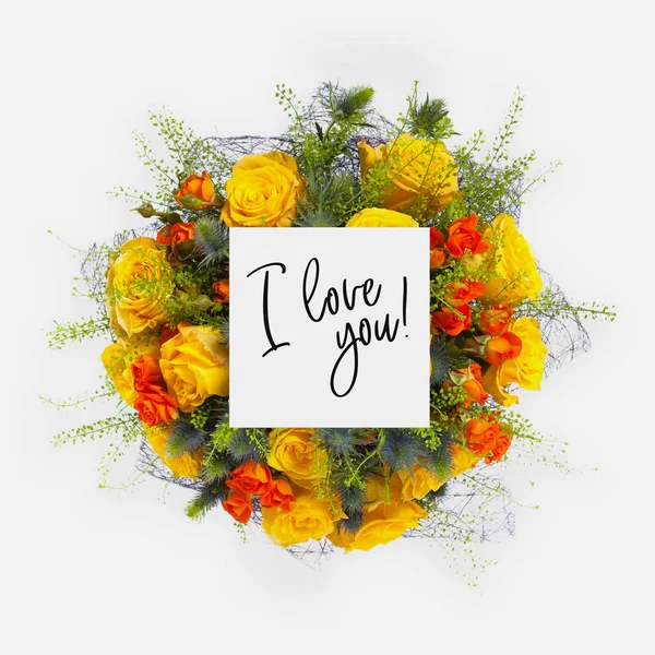 Fresh flowers bunch and card with words i love you written on it — Stock Photo, Image