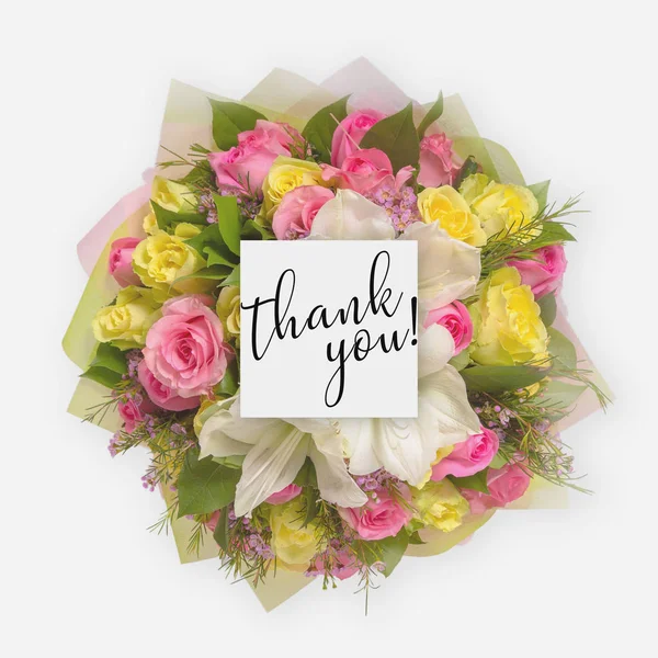 Fresh flowers bunch and card with words thank you written on it Stock