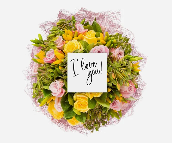 Fresh flowers bunch and card with words i love you written on it — Stock Photo, Image