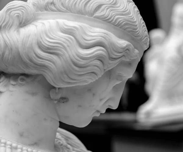 Paris, France, March 28 2017: White marble head of young woman. In Musee dOrsay, museum in Paris, on the left bank of the Seine — Stock Photo, Image