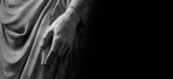 Man hand on antique tunic. Stone statue detail of human hand. Folds in the fabric. Copyspace for text — ストック写真