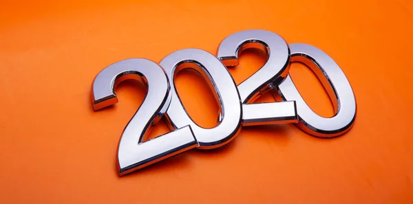 Feliz Año Nuevo 2020. Símbolo del número 2020 sobre fondo naranja. Letras de plata en forma de números 2020 . —  Fotos de Stock