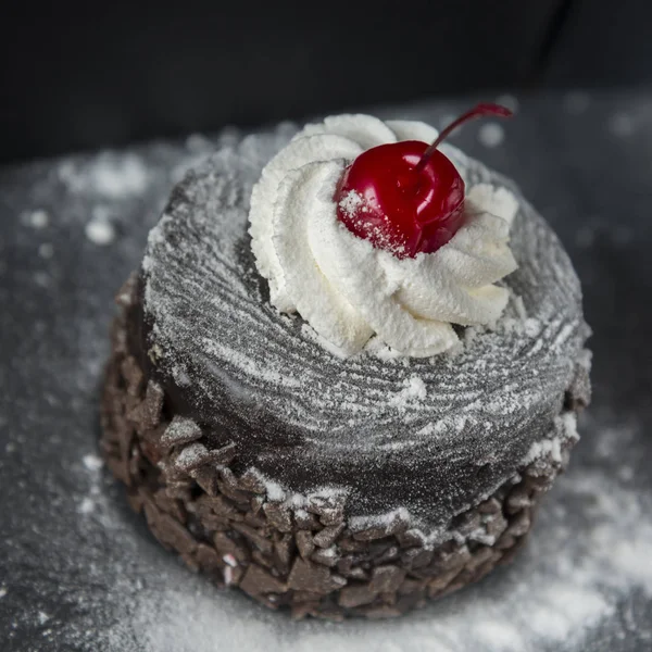 Chocolate cake with red cherry — Stock Photo, Image
