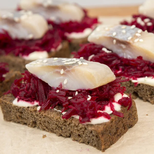 Canape  with a pickled herring and beetroot — Stock Photo, Image