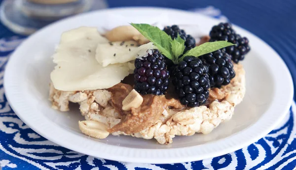 Snack with peanut butter, parmesan and fruit — Stock Photo, Image