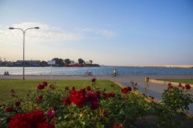 GDYNIA, POMERANIAN VOIVODESHIP / POLAND - JULY 27, 2018: View of the promenade in the city of Gdynia on the Baltic Sea at sunset
