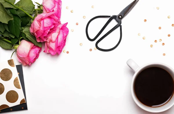 Pink roses, coffee and other things on white background — Stock Photo, Image