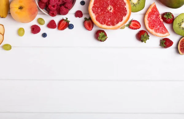 Fruits et baies sur le fond en bois blanc — Photo