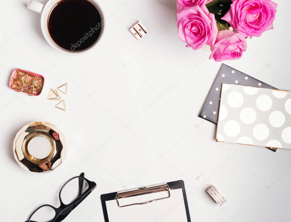 Feminine workplace concept: cofee, roses and small gold color ac