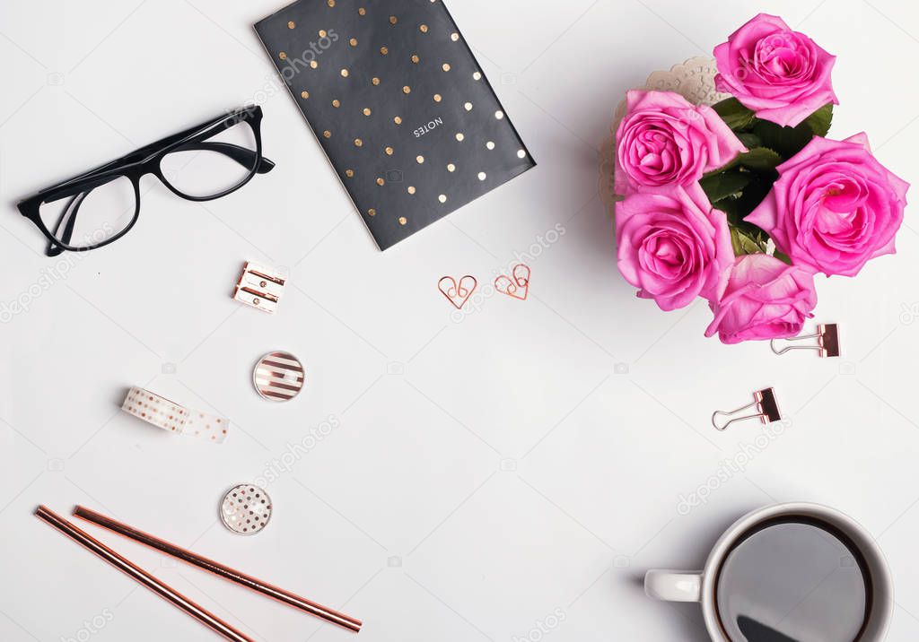 Coffee, glasses, pink roses and stylish gold stationery om the w