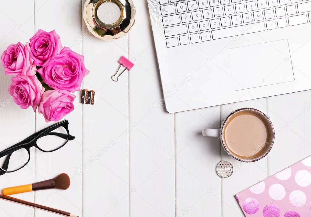 Modern stylish feminine workplace with coffee and roses