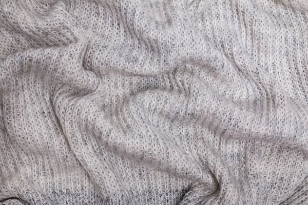 Texture of warm knitted woolen cloth, sweater or scarf of gray color Stock Picture