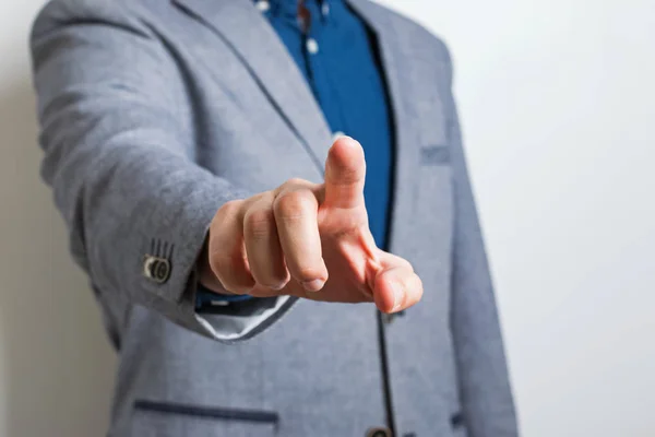 Man in suit pointing with his finger.