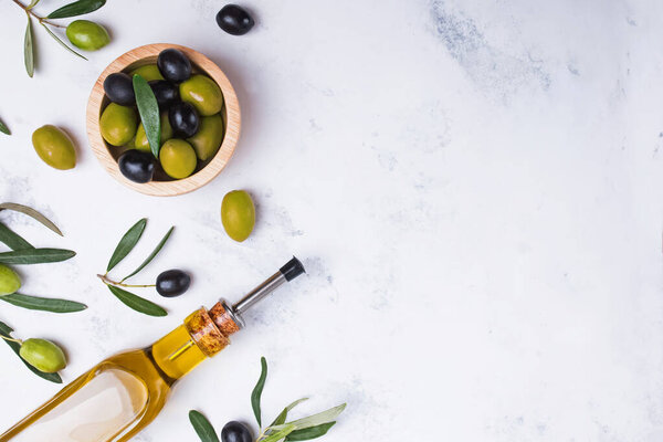 Glass bottle with extra virgin olive oil, fresh and matinated olives