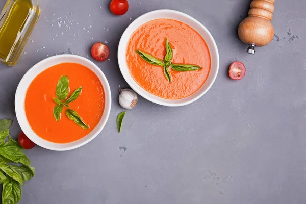 Tomato soup in bowls on gray stone table — Stock Photo, Image