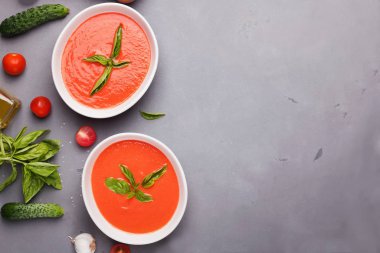 Cold tomato soup with olive oil in bowls
