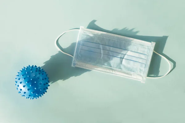Абстрактна вірусна модель MERS-Cov або коронавірусу 2019 та захисна маска на синьому фоні — стокове фото
