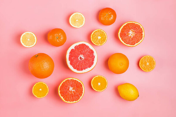 Flat lay composition with halves of different citrus fruits