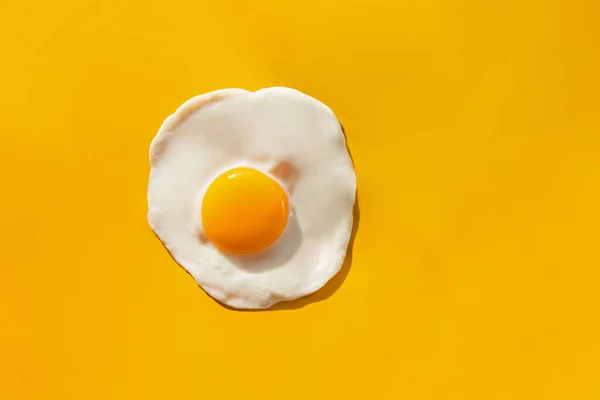 Gebakken ei op gele achtergrond — Stockfoto