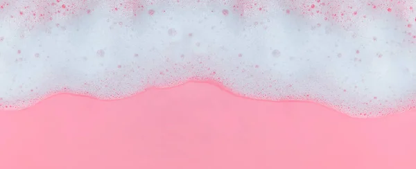 White soap foam with bubbles on pink background — Stock Photo, Image