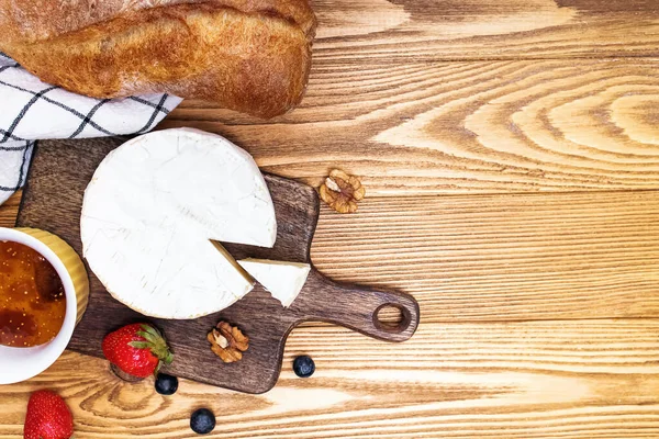 Peynir, şarap ekmeği ve çilek ahşap masada.. — Stok fotoğraf
