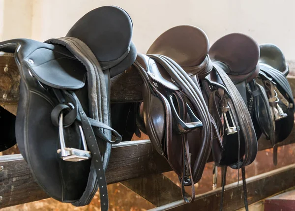 Rider Leather Saddles on fence — Stock Photo, Image