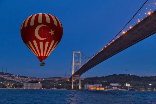 Red Hot Air balloons flying over Bosphorus Bridge at night. Ista
