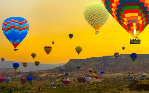 Sunset Hot air balloons landing in a mountain Cappadocia Goreme
