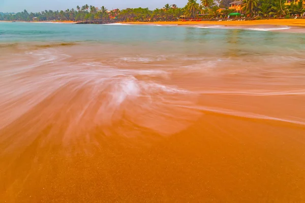 Low tide at sunset ocean wave — Stock Photo, Image