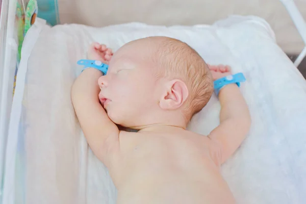 Newborn baby in crib — Stock Photo, Image