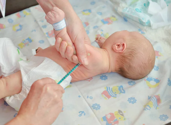 Doctor vaccinating newborn baby Stock Image