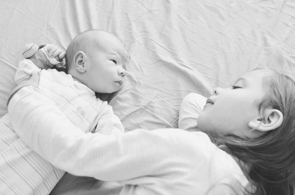 Little Sister Hugging Her Newborn Baby Brother — Stock Photo, Image