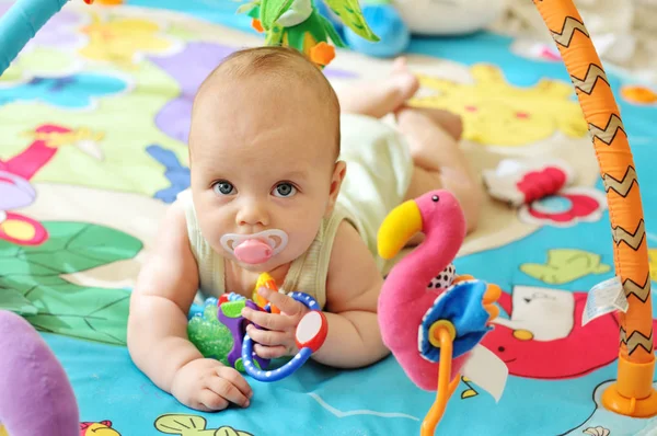 Baby on the toy rug — Stock Photo, Image