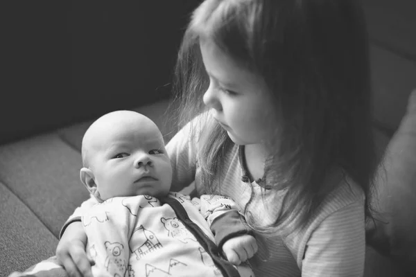 Sister Holding Her Newborn Brother Home — Stock Photo, Image