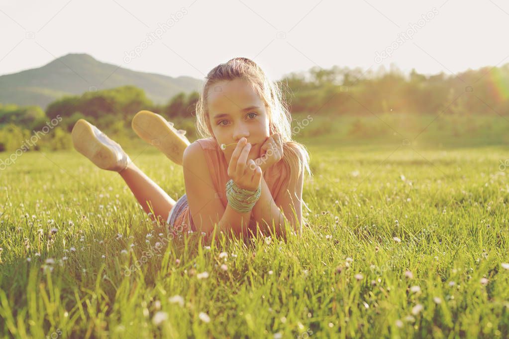 teen girl on the sunny meadow
