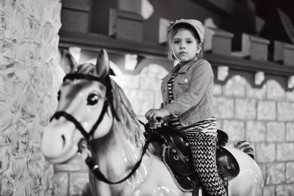 Little  girl on the  carousel hors — 스톡 사진