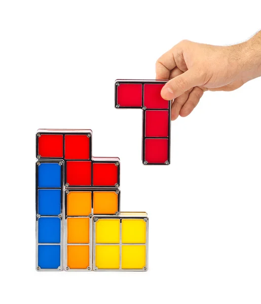Ruka s tetris hračka bloky — Stock fotografie