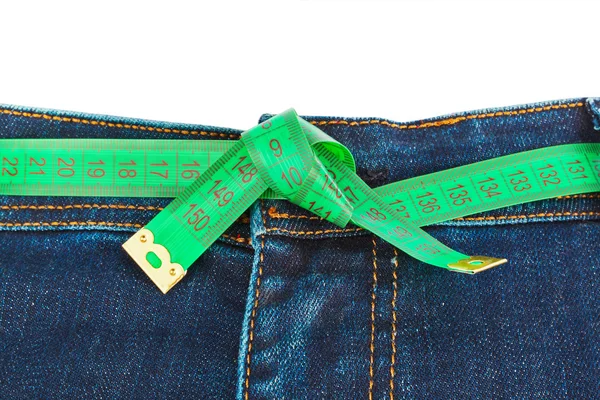 Jeans en meetlint - vermagering concept — Stockfoto