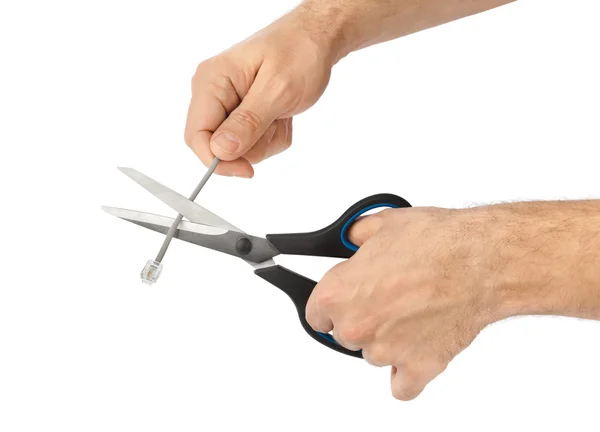 Рука з ножицями і телефонним кабелем — стокове фото
