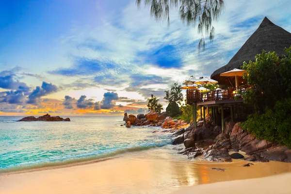Cafe on tropical beach at sunset Stock Image