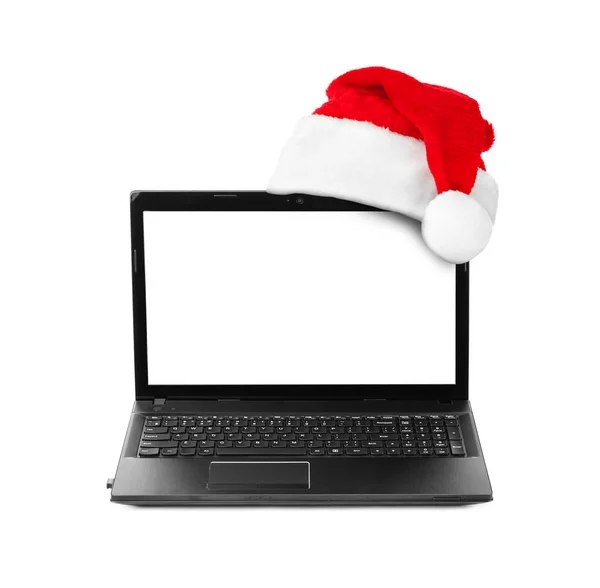 笔记本计算机和圣诞老人红色圣诞帽子 — 图库照片