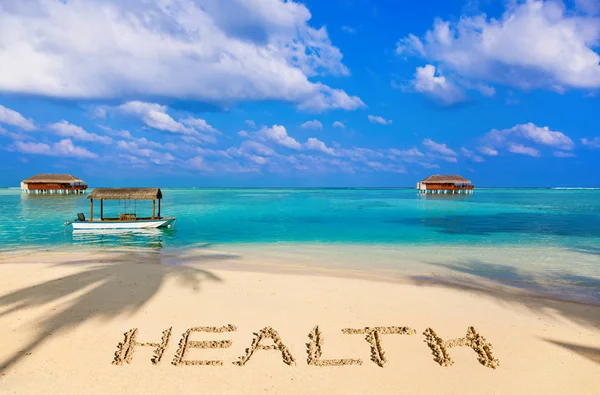 Ordet hälsa på stranden — Stockfoto