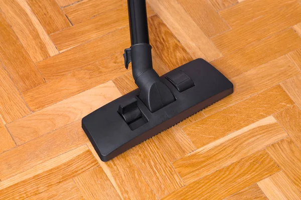 Vacuum cleaner on parquet — Stock Photo, Image