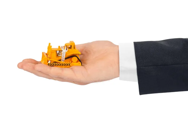 Hand med leksak bulldozer — Stockfoto