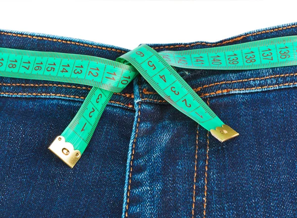 Jeans and measuring tape - slimming concept — Stock Photo, Image