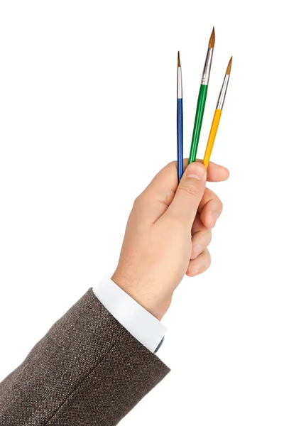 Рука с разноцветными кисточками — стоковое фото