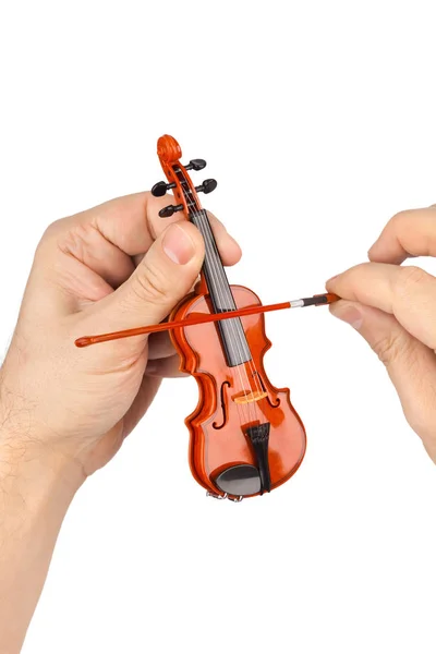 Mãos e violino brinquedo — Fotografia de Stock